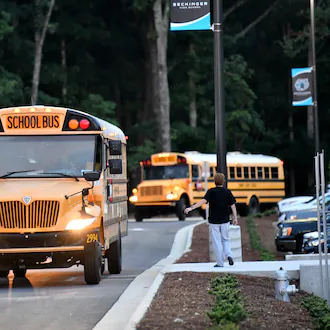 School buses arrived on the first day of school at Seckinger High School in Gwinnett County on Aug. 3, 2022. Gwinnett is one of several metro Atlanta school districts that are switching to remote learning on Monday. (Hyosub Shin/AJC)