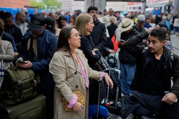 Travelers wait for news about their delayed trains at the Madrid train station, Spain, Monday, May 5, 2025. (AP Photo/Manu Fernandez)