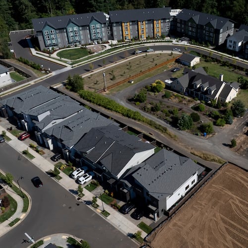 FILE - New construction homes and apartments are seen surrounding an older home on Friday, July 11, 2025, in Happy Valley, Ore. (AP Photo/Jenny Kane, File)