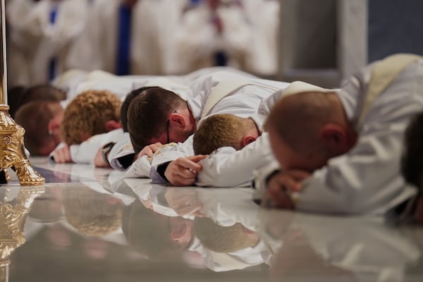 Twelve deacons prostrate in front of the altar at the Cathedral of Saint Thomas More during their ordination Mass in Arlington, Va., on Saturday, June 7, 2025. (AP Photo/Jessie Wardarski)