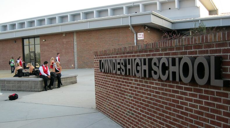 Students wait at the entrance of Lowndes High School before the school’s Oct. 11 football game. Sophomore Kendrick Johnson was found dead in the school gym last January. Mark Niesse/mark.niesse@ajc.com