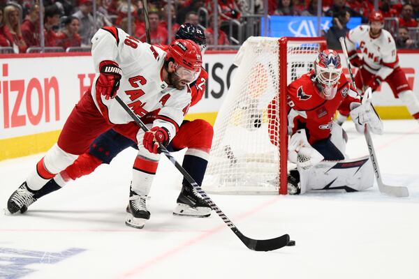 Carolina Hurricanes left wing Jordan Martinook (48) skates with the puck against Washington Capitals goaltender Logan Thompson, right, in the second period of Game 1 of a second-round NHL hockey playoff series Tuesday, May 6, 2025, in Washington. (AP Photo/Nick Wass)