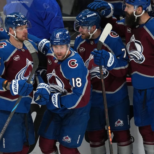 Colorado Avalanche center Jack Drury, center, is congratulated by, from left, center Nicolas Roy, right wing Valeri Nichushkin, and defensemen Devon Toews and Brent Burns in the third period of Game 5 of an NHL Stanley Cup hockey second-round playoff series against the Minnesota Wild Wednesday, May 13, 2026, in Denver. (AP Photo/David Zalubowski)