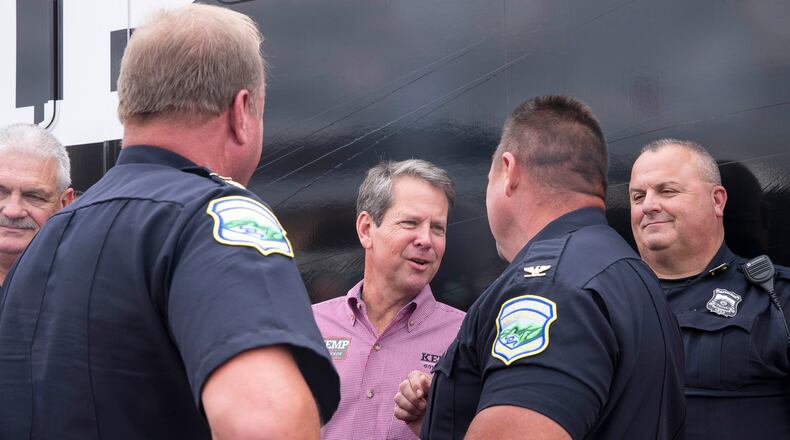 10/01/2018 -- Jasper, Georgia -- Georgia Republican Gubernatorial candidate Brian Kemp speaks with officers of the Jasper Police Department during a campaign stop at Appalachian Gun, Pawn & Range in Jasper, Monday, October 1, 2018. Monday was the first day of Brian Kemp's weeklong bus tour where he and his campaign will visit 27 counties in 5 days. (ALYSSA POINTER/ALYSSA.POINTER@AJC.COM)