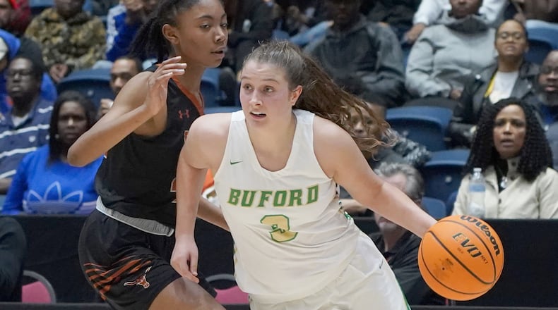 Buford's Tate Walters (3) drives around Kell's Amaya Moss during the Class AAAAA girls title basketball game Friday, March 6, 2020, at the Macon Centreplex in Macon.