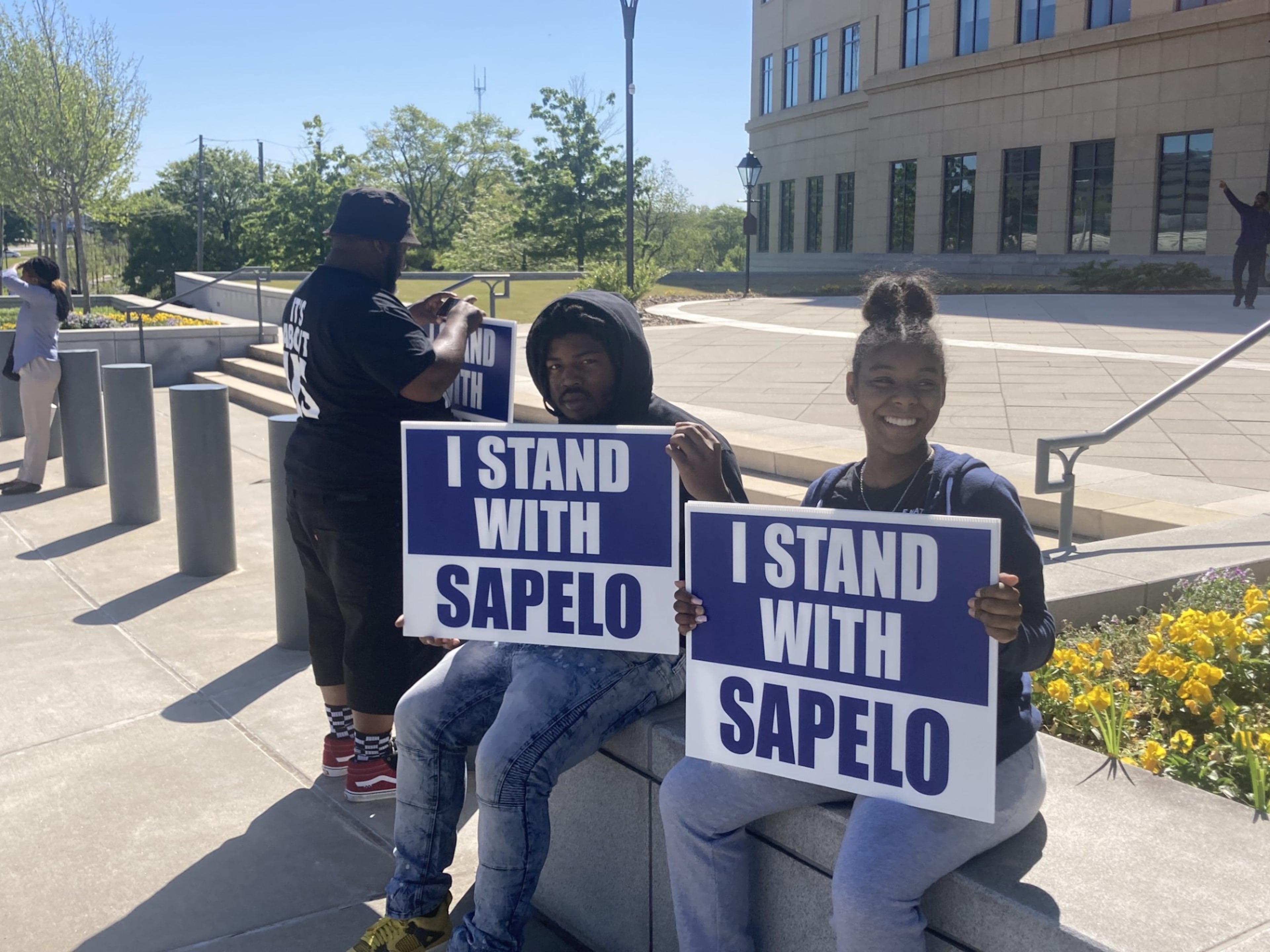 Supporters of Sapelo Island's Gullah Geechee residents held signs in front of the Nathan Deal Judicial Center during a hearing.