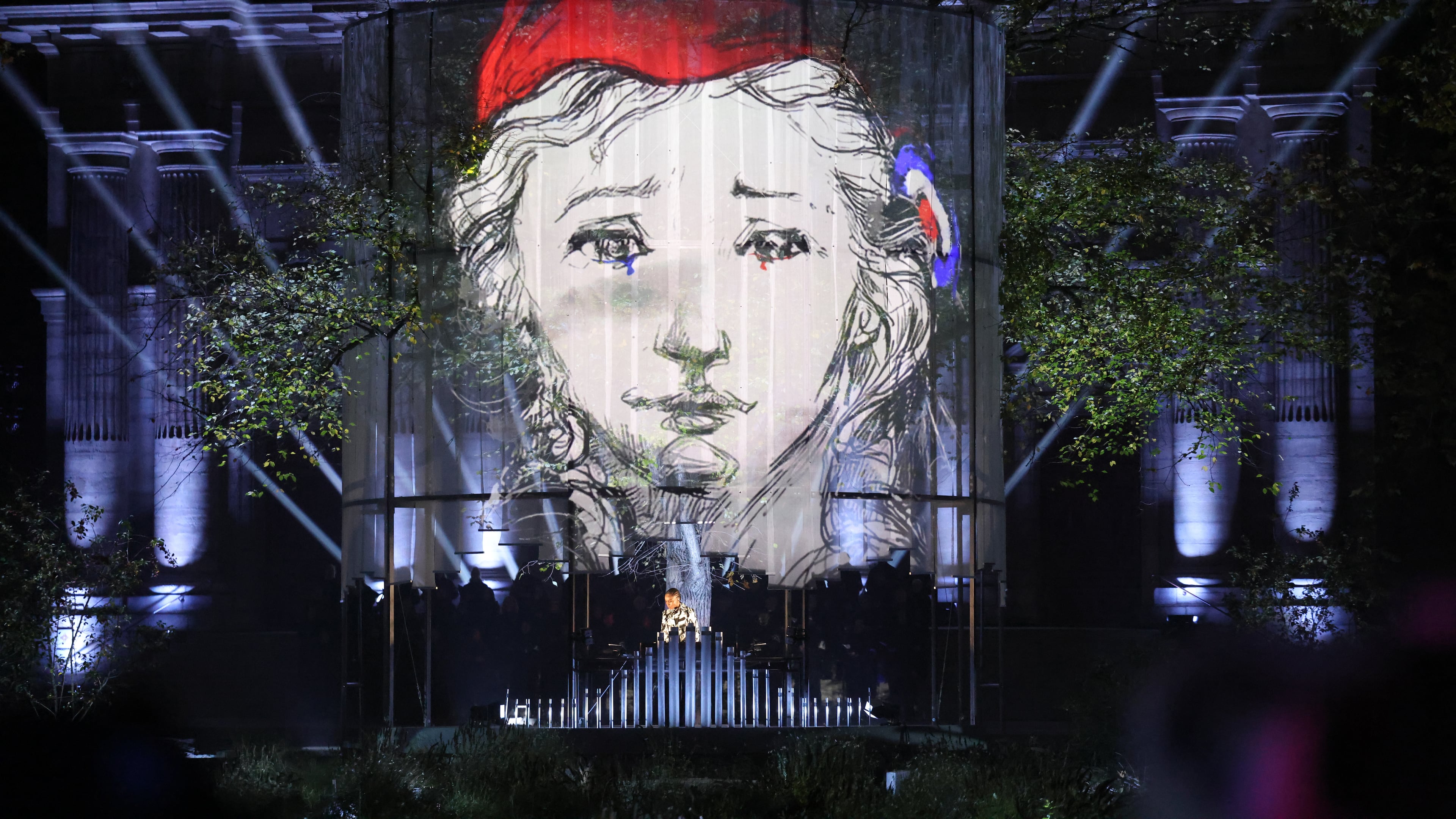 A DJ performs at the "Jardin du 13 novembre 2015" inaugurated Thursday Nov. 13, 2025 in Paris as part of ceremonies marking the 10th anniversary of terrorist attacks that killed 132 people and injured hundreds. (Ludovic Marin, Pool photo via AP)