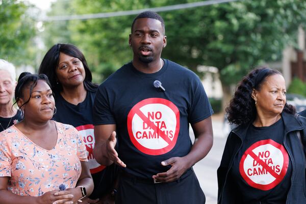 KeShaun Pearson (center), executive director of Memphis Community Against Pollution, speaks in opposition to the development of data centers in DeKalb County in June in Decatur. (Estela Muñoz/AJC)