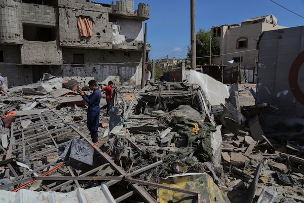 Palestinians inspect the wreckage of a gas station destroyed in an Israeli airstrike in Deir al-Balah, central Gaza Strip, Saturday, July 12, 2025. (AP Photo/Abdel Kareem Hana)