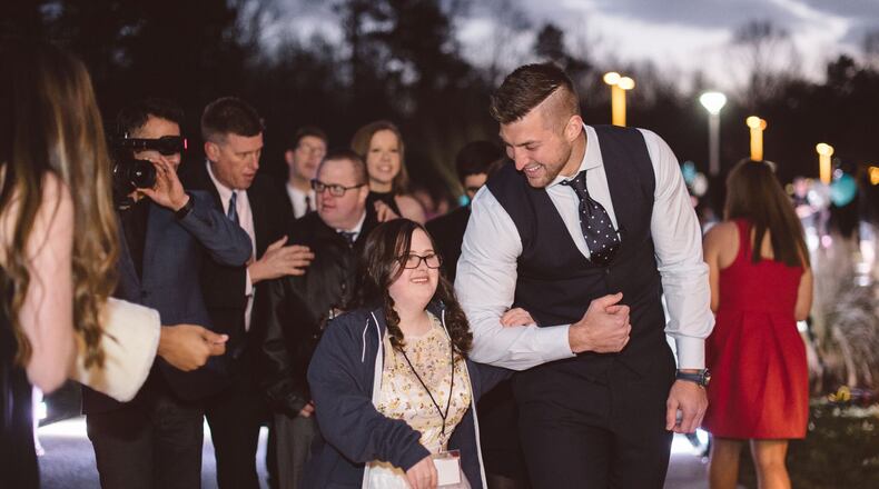 Tim Tebow escorts a young lady to the 2016 Night to Shine event. Photo courtesy of the Tim Tebow Foundation