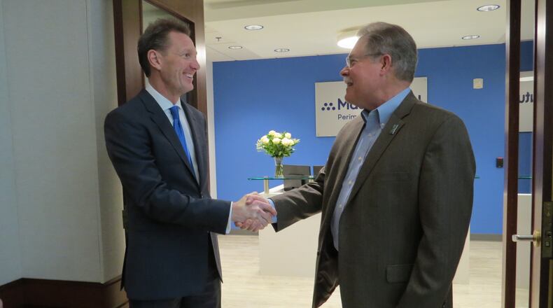 Peachtree Corners Mayor Mike Mason (right) after the ribbon-cutting congratulating Jeffrey Bulvin, General Agent of MassMutual Perimeter on their relocation to the city. (Courtesy Peachtree Corners)