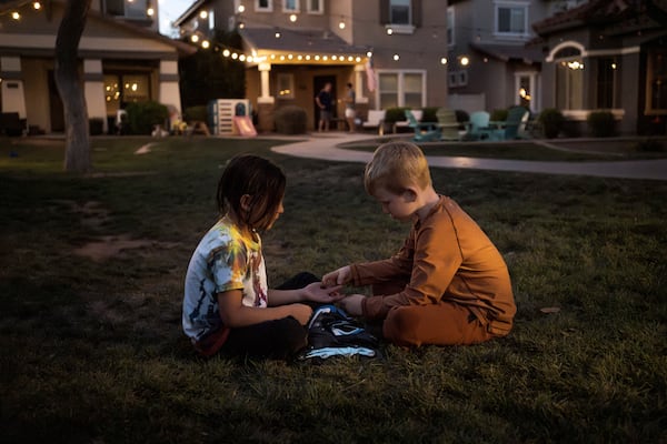 Maverick, left, and Brennan, right, play in Agritopia's "kid pod," a cluster of families with more than 20 kids between them at Agritopia, a community nestled around a plot of agricultural land, on April 21, 2025, in Gilbert, Ariz. (AP Photo/Annika Hammerschlag)