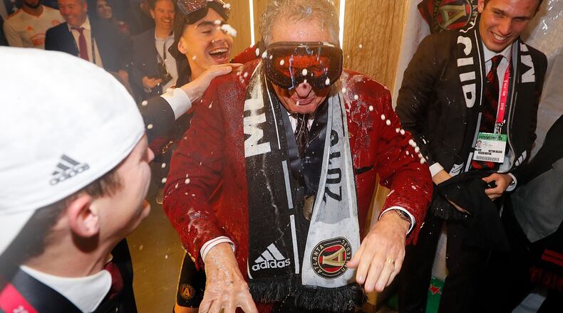No one is safe: Atlanta United owner Arthur Blank is doused by Miguel Almiron during the MLS Cup celebration.