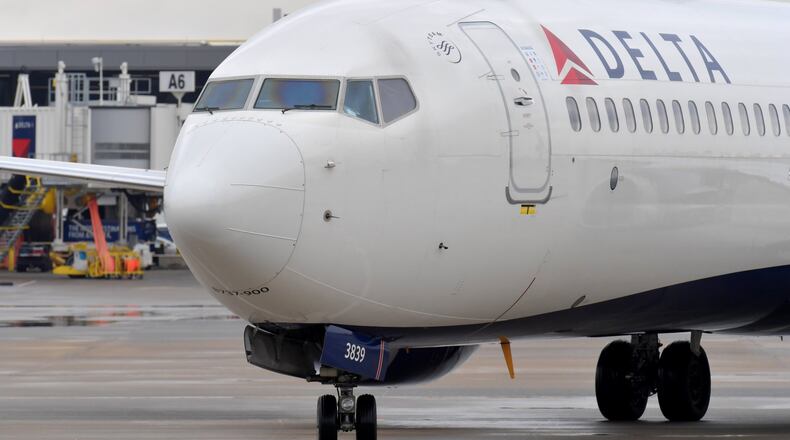 Delta plane approaches gate at Hartsfield-Jackson. HYOSUB SHIN / HSHIN@AJC.COM