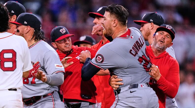 Washington Nationals' Cade Cavalli, front right, is held back as tempers flare during the fourth inning of a baseball game against the Boston Red Sox, Tuesday, June 30, 2026, in Boston. (AP Photo/Charles Krupa)