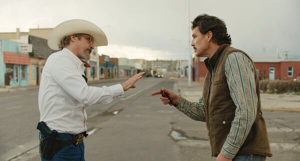This image released by A24 shows Joaquin Phoenix, left, and Pedro Pascal in a scene from "Eddington." (A24 via AP)