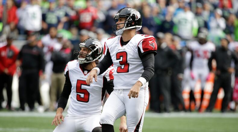 Atlanta Falcons kicker Matt Bryant, right, watches after he kicked a field goal with punter Matt Bosher (5) holding, in the first half of an NFL football game, Sunday, Oct. 16, 2016, in Seattle. (AP Photo/Elaine Thompson)