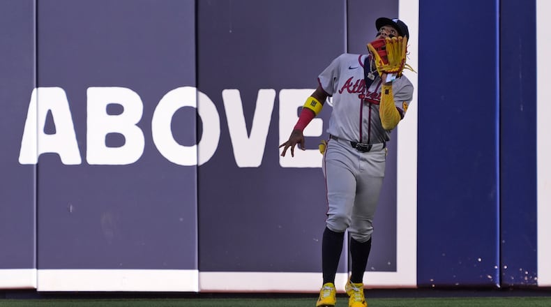 Atlanta Braves right fielder Ronald Acuna Jr. catches a ball hit by Miami Marlins' Vidal Brujan during the fifth inning of a baseball game, Saturday, April 13, 2024, in Miami. (AP Photo/Wilfredo Lee)