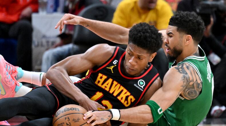 Hawks forward De'Andre Hunter fights for a loose ball with Celtics forward Jayson Tatum (right) during the second half of Game 4 of the first round of the Eastern Conference playoffs at State Farm Arena, Sunday, April 23, 2023, in Atlanta. The Celtics won 129-121. (Hyosub Shin / Hyosub.Shin@ajc.com)