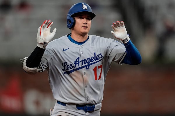 Los Angeles Dodgers two-way player Shohei Ohtani (17) celebrates his solo homer against the Atlanta Braves in the third inning of a baseball game, Saturday, May 3, 2025, in Atlanta. (AP Photo/Mike Stewart)