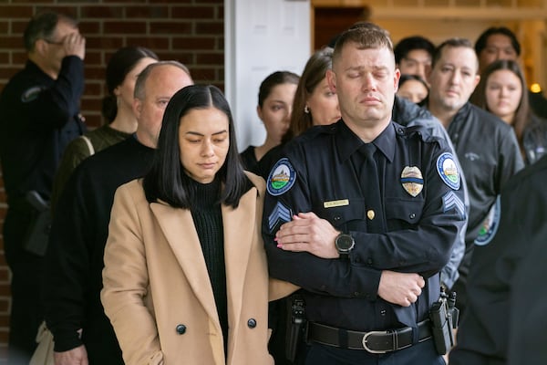 Fallen Roswell police officer Jeremy Labonte’s wife Alyssa (left) and officer S.A. Wolfson are seen before Labonte’s procession at Northside Chapel in Roswell on Feb. 11. The 24-year-old Roswell Police Department officer was shot to death. (Arvin Temkar/AJC)
