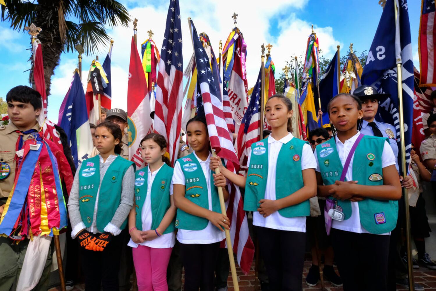 scouts place flags at veteran graves to honor memorial day