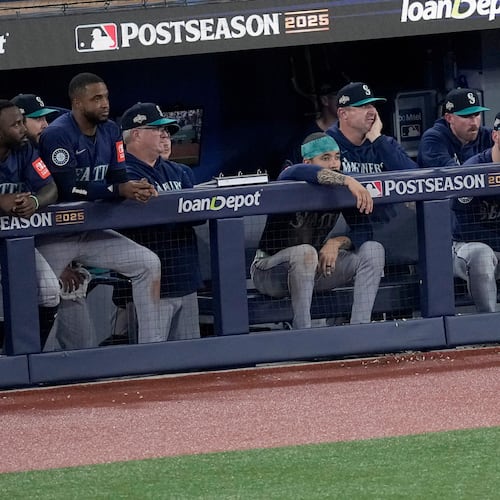 The Seattle Mariners watch from their dugout during the ninth inning in Game 7 of baseball's American League Championship Series against the Toronto Blue Jays, Monday, Oct. 20, 2025, in Toronto. (AP Photo/David J. Phillip)