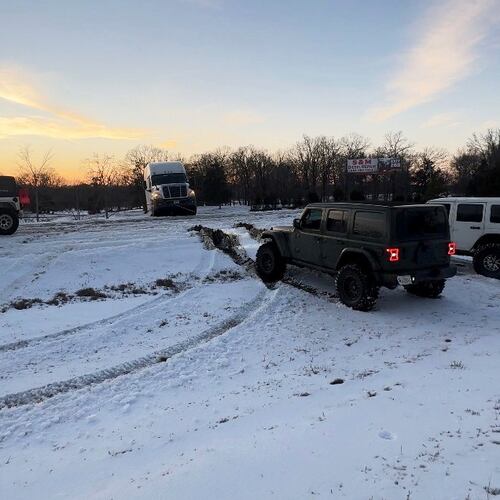 This photo provided by Crystal Walk shows Jeeps helping stranded drivers navigate the ice on Wednesday, Jan. 28, 2026, on Interstate 55 in northern Mississippi. (Crystal Walk via AP)