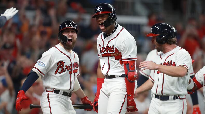 Atlanta Braves left fielder Ronald Acuna reacts after hitting a grand slam home run with center fielder Ender Inciarte, left, in the second inning against the Los Angeles Dodgers in Game 3 of a National League Division Series baseball game Sunday, October 7, 2018, in Atlanta. Curtis Compton/ccompton@ajc.com