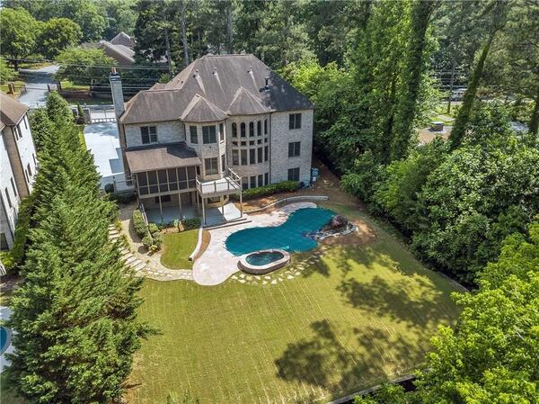 View of the Decatur home’s private backyard and pool with spa.