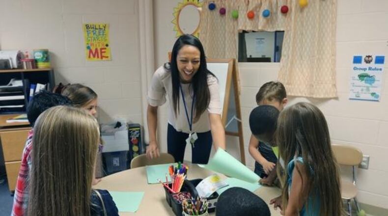 A school counselor works on social-emotional learning lessons with elementary school students