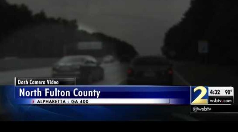 Dash cam video shows a woman not moving over a lane as a police officer was making a traffic stop.