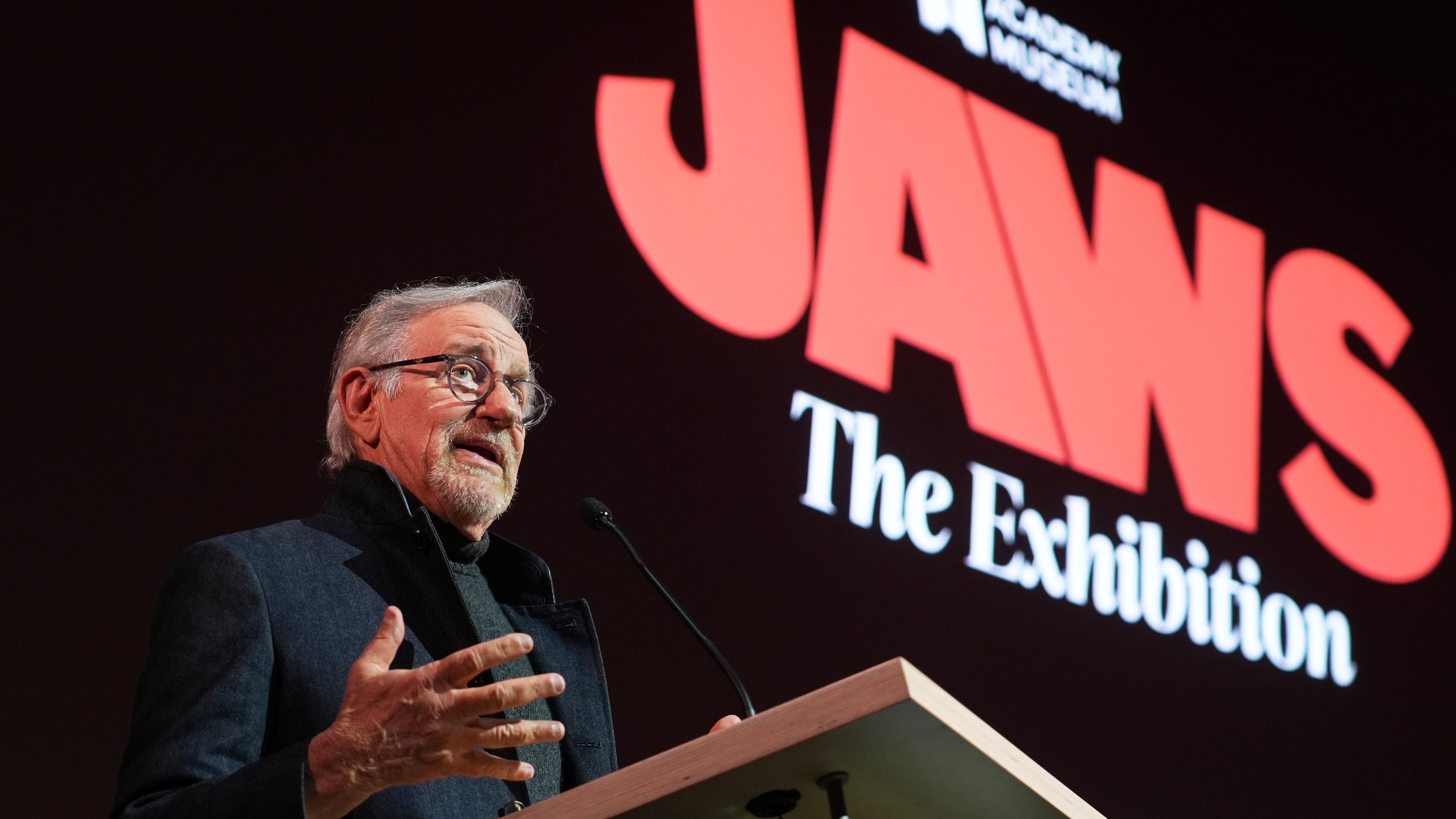 Steven Spielberg, director of the 1975 film "Jaws," addresses the audience during the "Jaws: The Exhibition" press preview on Wednesday, Sept. 10, 2025, at the Academy Museum of Motion Pictures in Los Angeles. (AP Photo/Chris Pizzello)