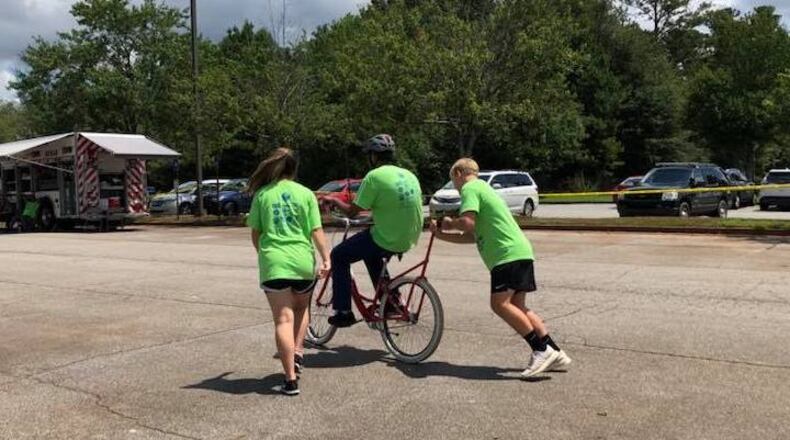 Volunteers are needed at iCan Bike Alpharetta to assist individuals with disabilities to learn to ride a bike. (Courtesy iCan Bike Alpharetta)