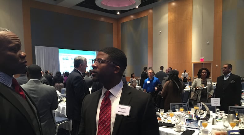 Shannon James, right, speaks Thursday to a colleague at the Annual State of the Aerotropolis Breakfast at the Georgia International Conference Center. James is the incoming chairman of the Aerotropolis Atlanta Alliance, a business group focusing on promoting development around Hartsfield-Jackson International Airport. (LEON STAFFORD AJC/lstafford@ajc.com)