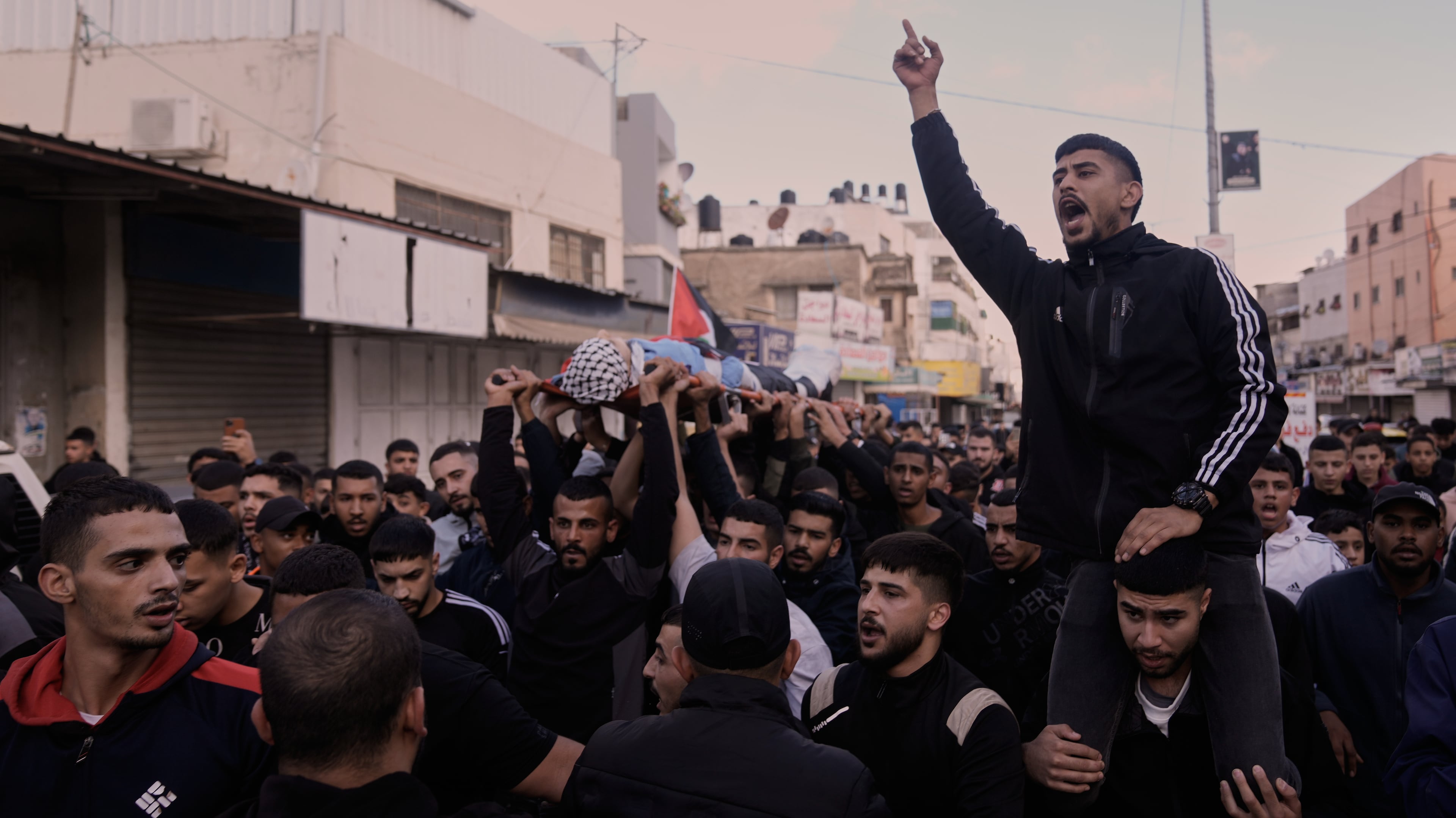 Mourners carry the body of the Palestinian Hassan Ahmed Jamil Moussa,19, who, according to health authorities, was killed during an Israeli raid last night, during his funeral in the Askar camp near the West Bank city of Nablus, Sunday, Nov. 16, 2025. (AP Photo/Majdi Mohammed)