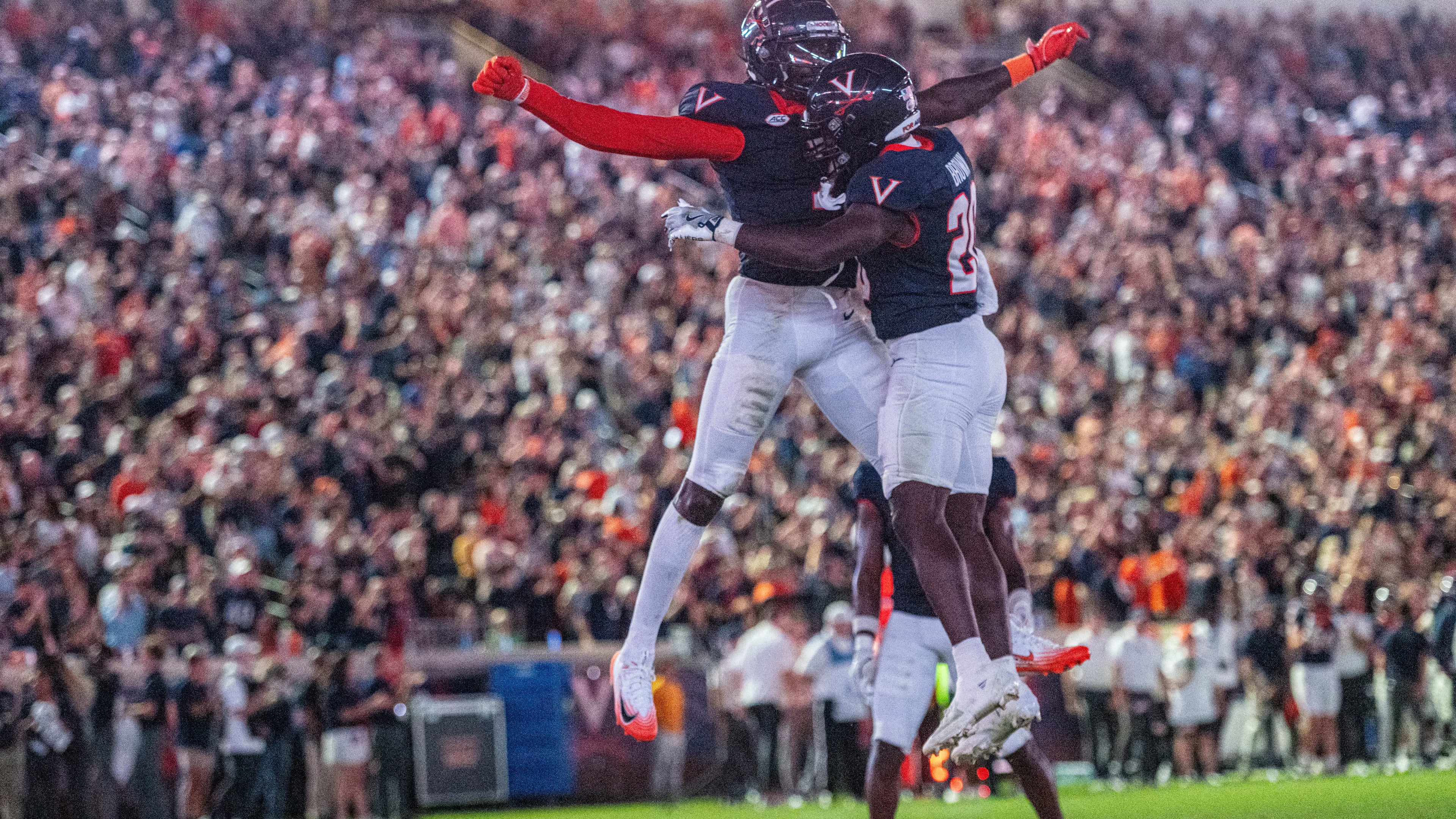 Virginia running back Xavier Brown (20) Virginia wide receiver Andre Greene Jr. (2) celebrate after a touchdown during the second half of an NCAA college football game, Friday, Sept. 26 2025, in Charlottesville, Va. (AP Photo/Robert Simmons)
