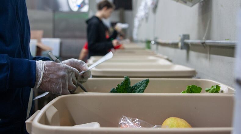 Fresh Harvest produce is packed in reusable plastic bins. At the end of the packing line, a checker makes sure everything the customer ordered is in the box. CONTRIBUTED BY FRESH HARVEST
