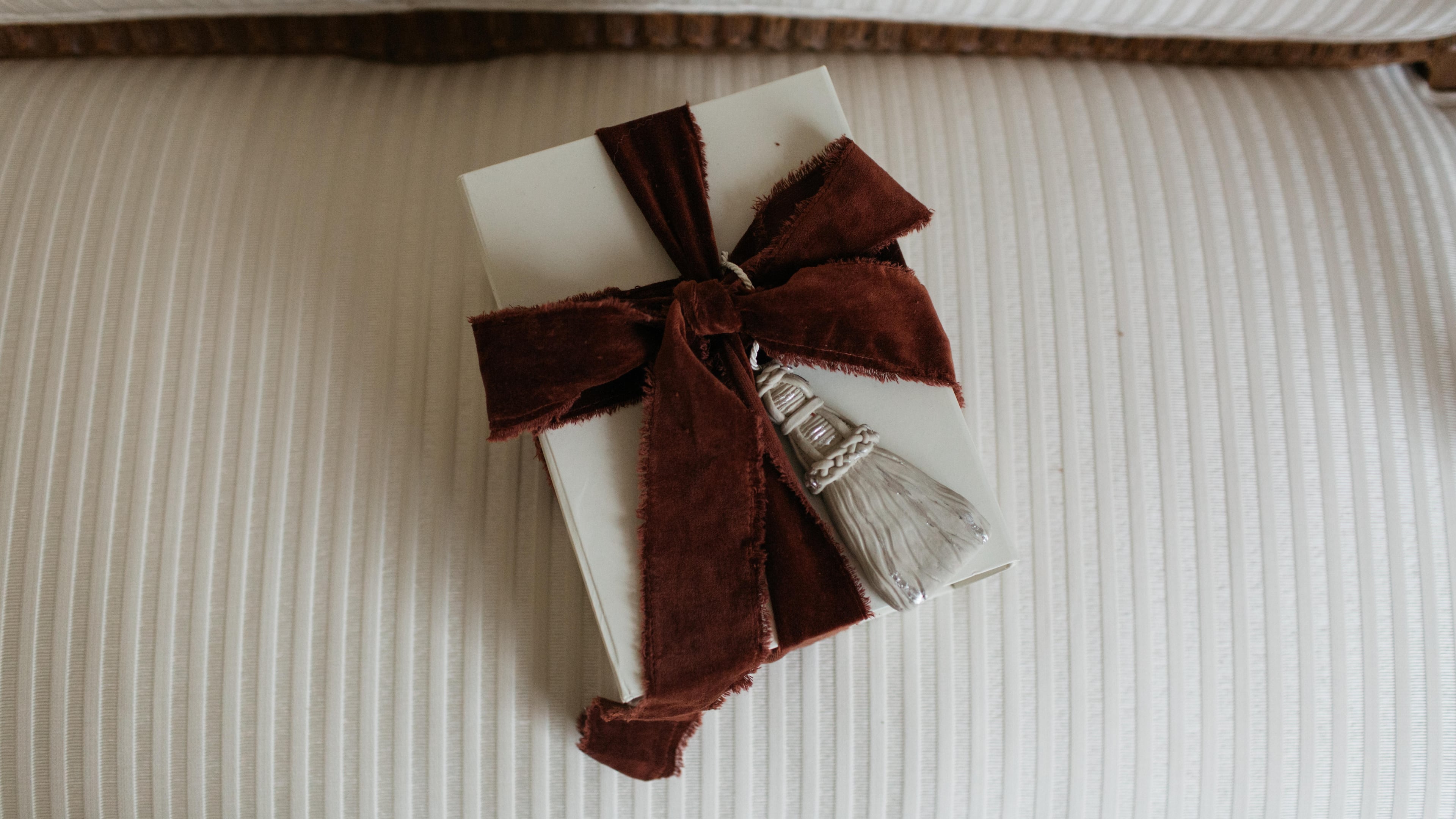 A gift wrapped with Page House Studio’s sculptural Tassel Ornament — a handcrafted piece that doubles as a keepsake and one of the Atlanta design studio’s most elevated holiday offerings. (Courtesy of Anna Howard)