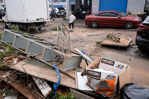 Jennifer Siegel-Luersen stands in a street filled with flood debris in North Plainfield, N.J., Tuesday, July 15, 2025. (AP Photo/Seth Wenig)