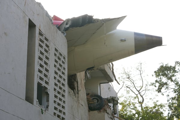 The debris of an airplane sticks out of a building after it crashed in India's northwestern city of Ahmedabad in Gujarat state, Thursday, June 12, 2025. (AP Photo/Ajit Solanki)