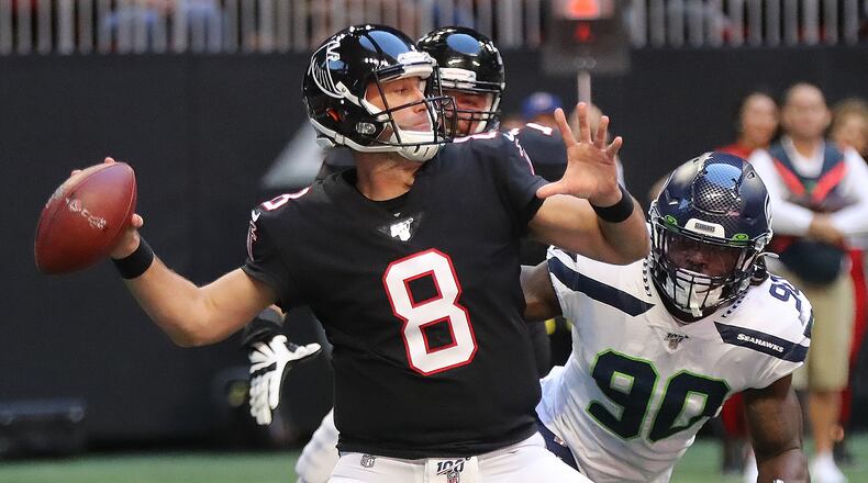 Atlanta Falcons quarterback Matt Schaub completes a pass under pressure from Seattle Seahawks defensive end Jadeveon Clowney during the second quarter in an NFL football game on Sunday, October 27, 2019, in Atlanta.   Curtis Compton/ccompton@ajc.com