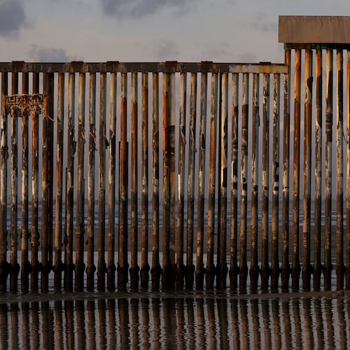 FILE - A man takes an image with his phone next to where the border wall separating Mexico and the United States reaches the Pacific Ocean Jan. 28, 2025, in Tijuana, Mexico. (AP Photo/Gregory Bull, File)