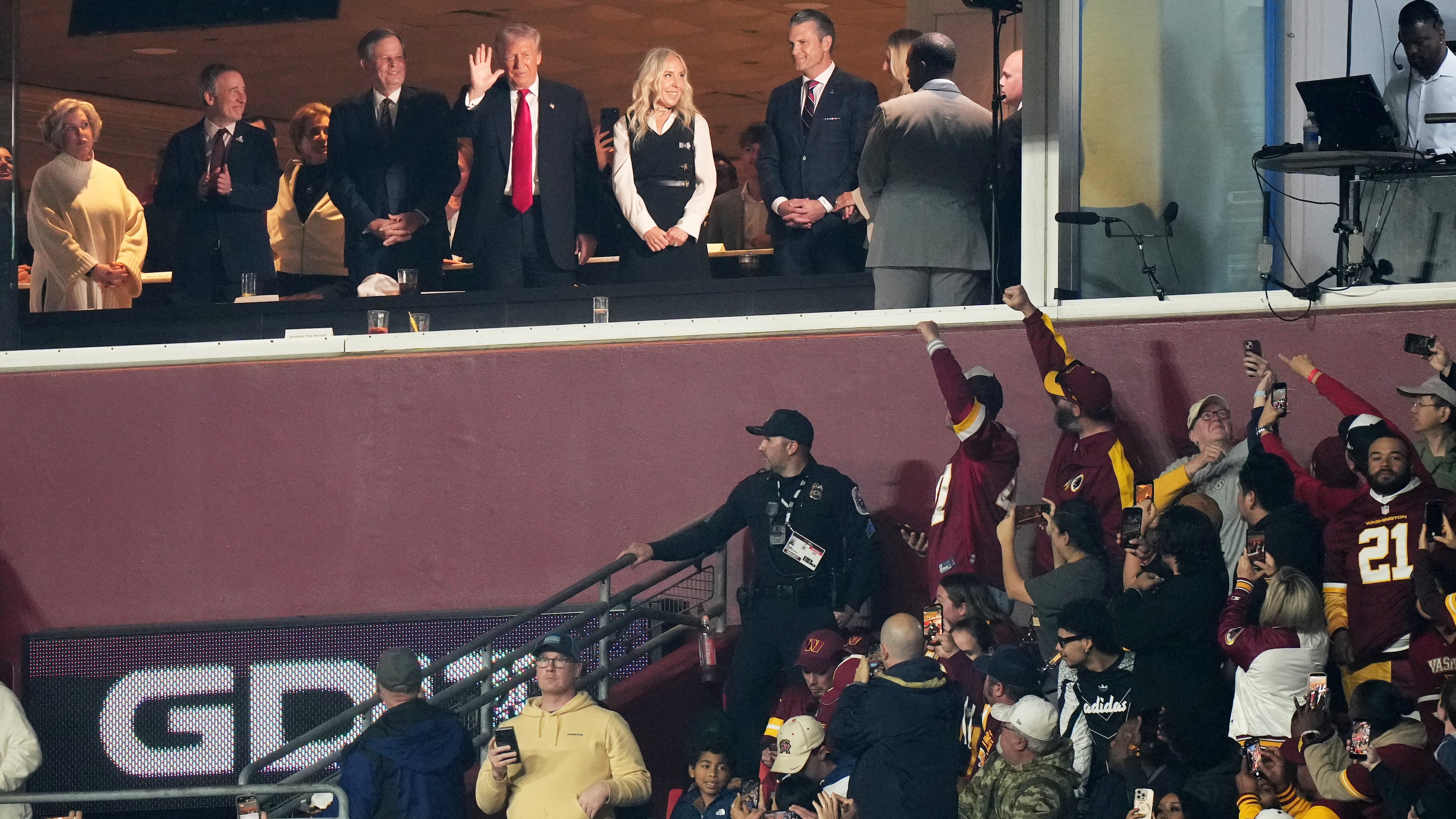 President Donald Trump is seen in a suite during the first half of an NFL football game between the Washington Commanders and the Detroit Lions Sunday, Nov. 9, 2025, in Landover, Md. (AP Photo/Stephanie Scarbrough)