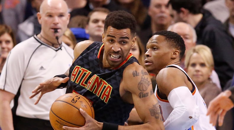 Atlanta Hawks forward Thabo Sefolosha, left, drives around Oklahoma City Thunder guard Russell Westbrook, right, in the first half of an NBA basketball game in Oklahoma City, Monday, Dec. 19, 2016. (AP Photo/Sue Ogrocki)