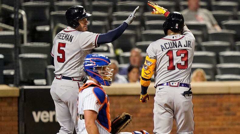 Freddie Freeman greets Ronald Acuña after Acuña's home run in the fifth inning of Monday's Game 2 of a doubleheader against the Mets.