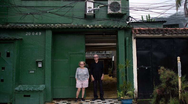 Nelson Faria Marinho and Maria Eva Marinho, who lost their son Nelson Marinho in the Air France flight 447 plane crash near the coast of Brazil on June 1, 2009, pose for a photo outside their home, where a sign with the flight number hangs in Rio de Janeiro, Thursday, May 21, 2026. (AP Photo/Bruna Prado)