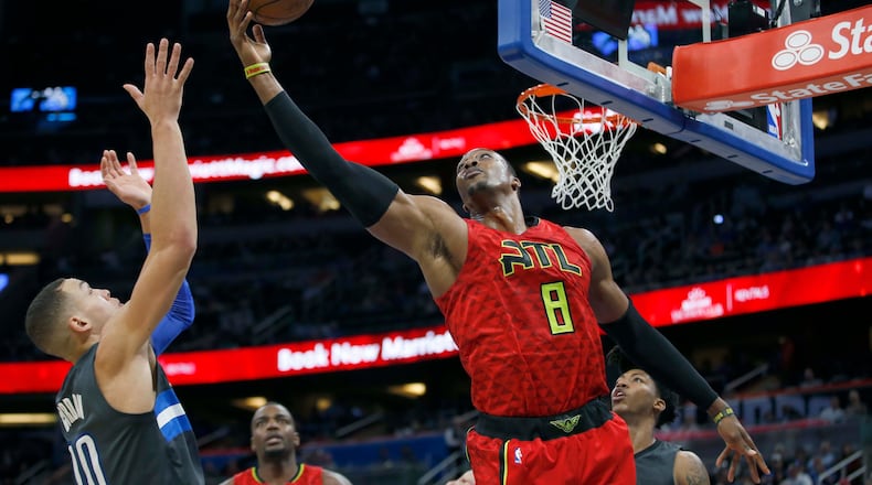 Atlanta Hawks center Dwight Howard (8) and Orlando Magic forward Aaron Gordon (00) go for a rebound during the second quarter of an NBA basketball game in Orlando, Fla., Saturday, Feb. 25, 2017. (AP Photo/Reinhold Matay)