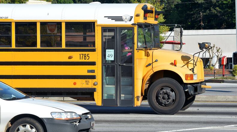 A DeKalb County school bus sits in traffic at Memorial Drive and Hairston Road.