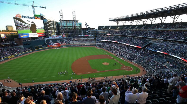 Fans cheer after the national anthem before the exhibition game between the New York Yankees and the Atlanta Braves at SunTrust Park stadium Friday, March 31, 2017. The new home of the Braves seats 41,149 and took 30 months to build. JASON GETZ / SPECIAL